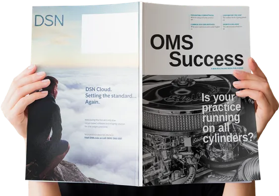 A reader holding open a print copy of OMS Success magazine